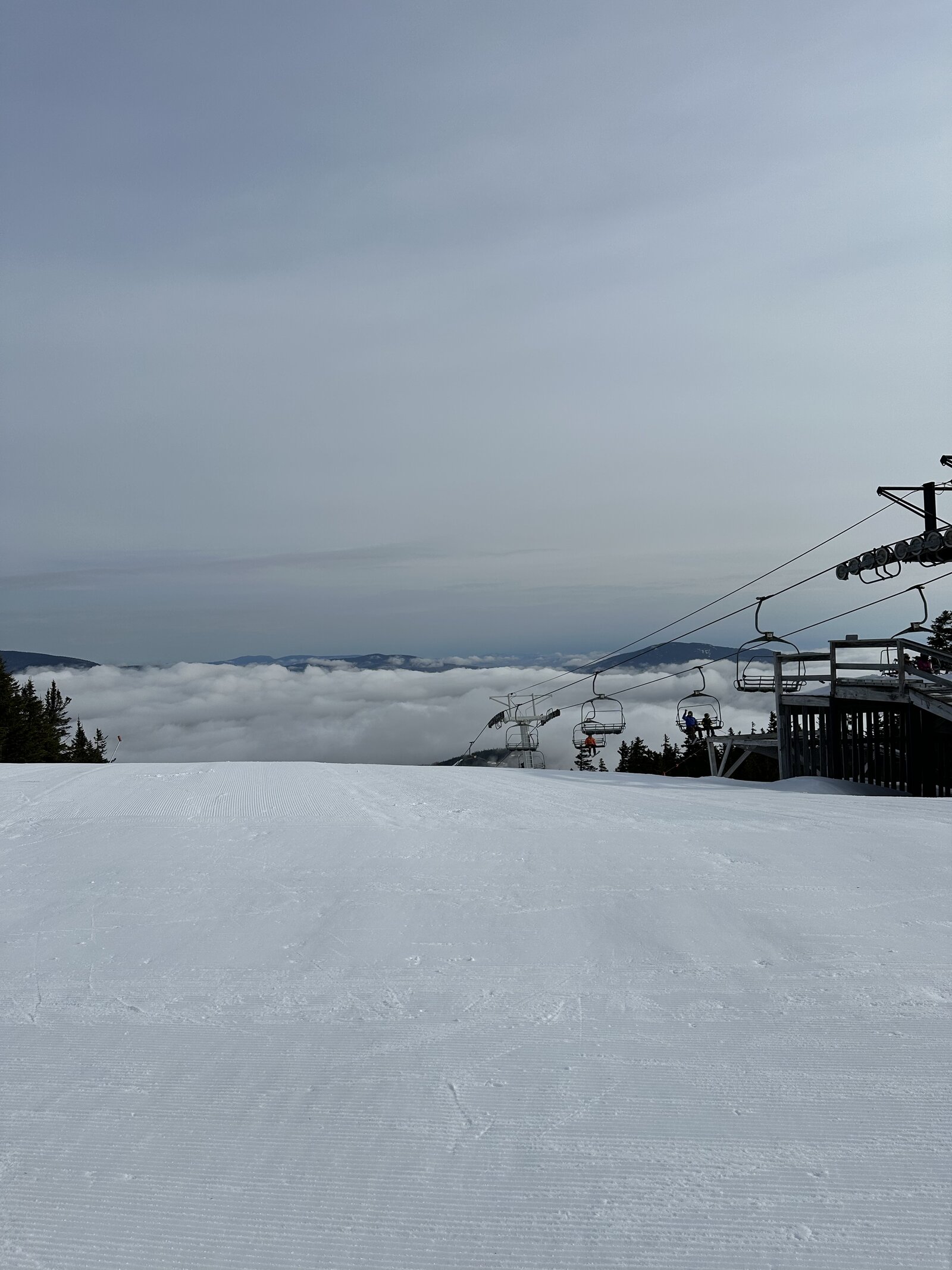 Chairlift rising above the clouds