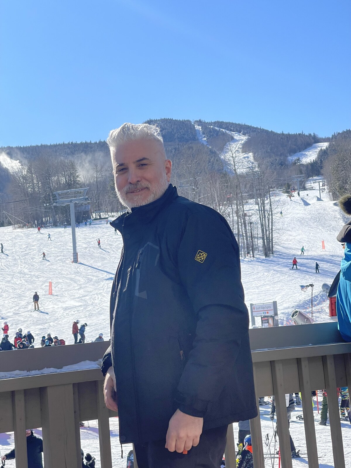 Daniel Kaufman on a mountain resort deck overlooking the slopes