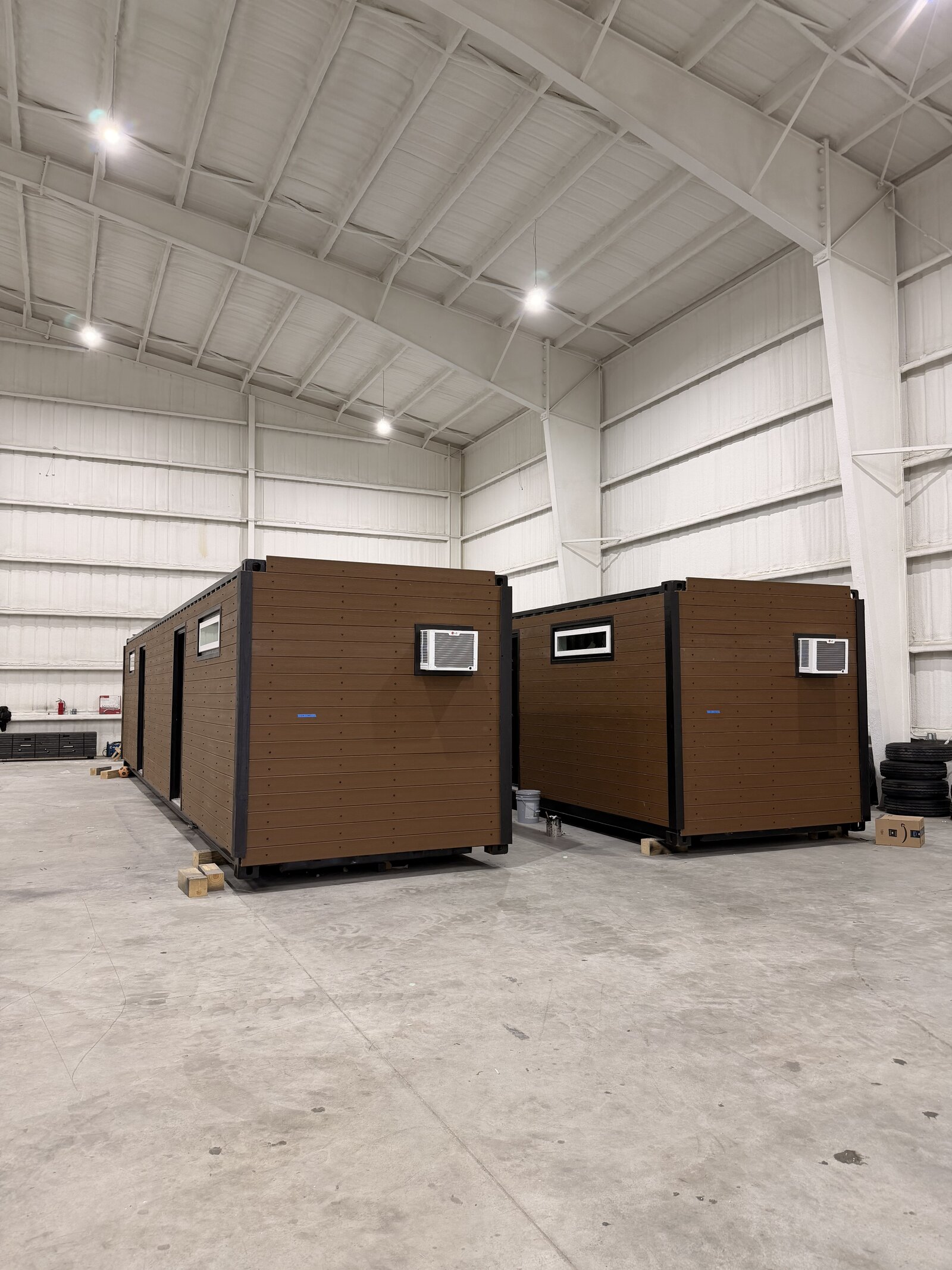 Two finished Mr. Good Container Homes duplex units in the manufacturing warehouse