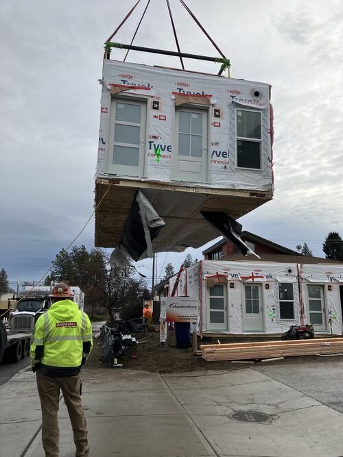 A crane setting a modular unit onto the Project Zero building