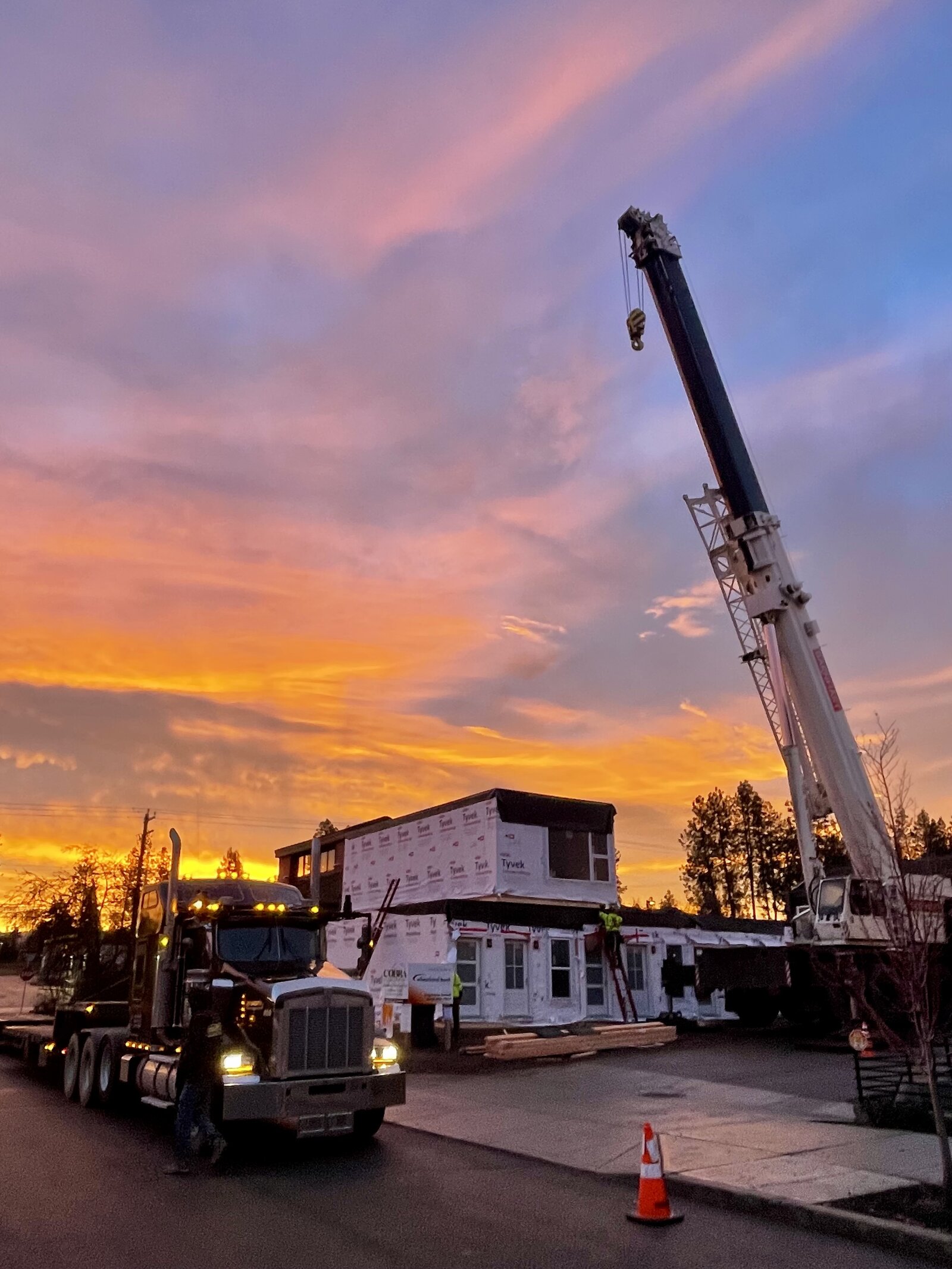 A finished module being trucked to the Project Zero site at sunset